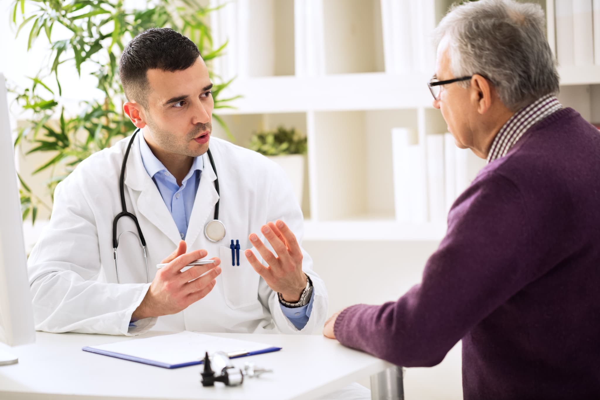 Image of doctor speaking with elderly man